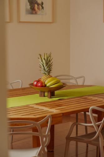 a wooden table with a plate of fruit on it at Sammit holiday home in Michelica