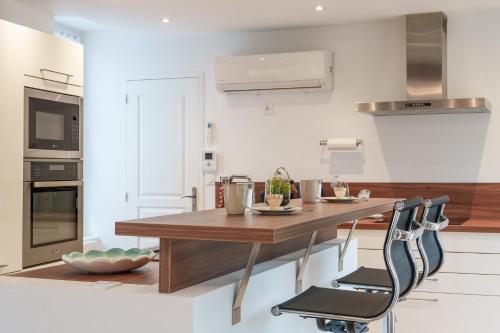 a kitchen with a wooden table and chairs at Maison centre Bourgueil avec piscine 8 p in Bourgueil