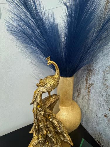 a gold peacock statue sitting on top of a vase at Gloucester - Apartment - Sleeps 2 - Parking - 97WS in Gloucester