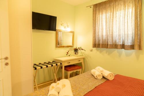 a bedroom with a bed and a sink and a mirror at 99 Luxury Exotic Villas in Nafplio
