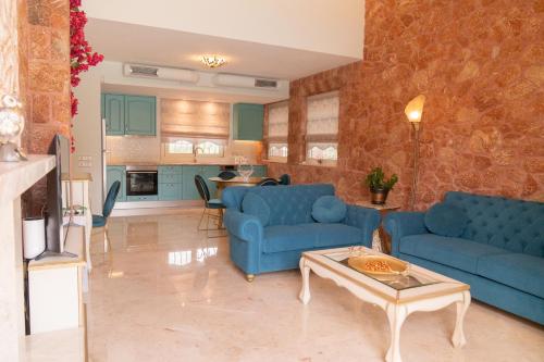 a living room with blue couches and a table at 99 Luxury Exotic Villas in Nafplio