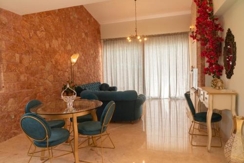 a living room with a table and a couch at 99 Luxury Exotic Villas in Nafplio