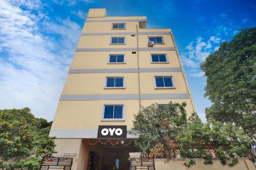 a tall building with a sign on it at Hotel O Shri Ganesh Near By Himayatnagar,Ashok Nagar,RTC X Roads in Hyderabad