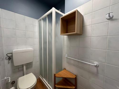 a bathroom with a toilet and a shower at San Matteo Apartments in Loano