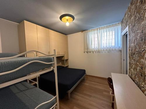 a room with two bunk beds and a table at San Matteo Apartments in Loano