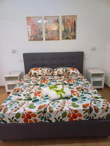 a bedroom with a bed with a colorful bedspread at Studio 49 - da Frank in Giardini Naxos