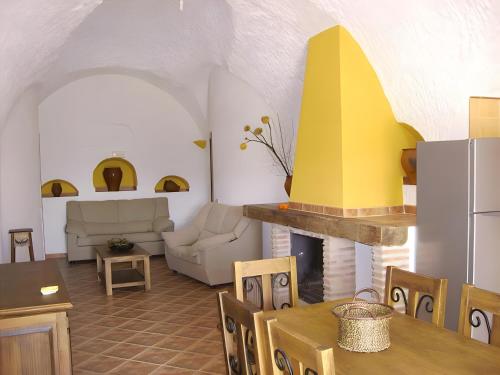 a kitchen and living room with a fireplace at El Olivo in Benalúa de Guadix