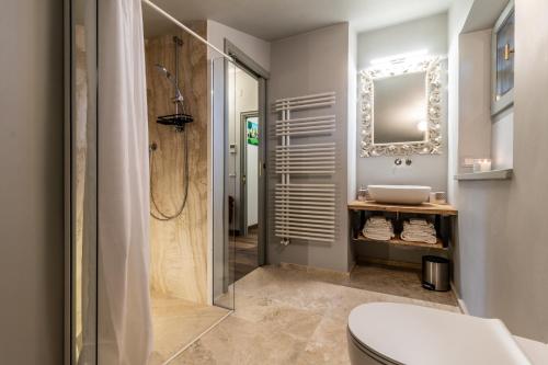 a bathroom with a shower and a toilet and a sink at Villa Porri by MMega in Siena