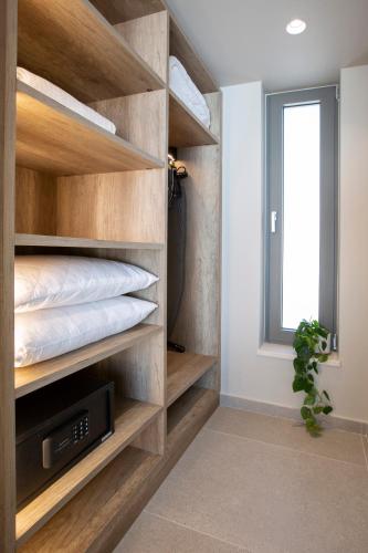 a bedroom with wooden shelves and a bed at Brand new High-end villa Solar in Sivota