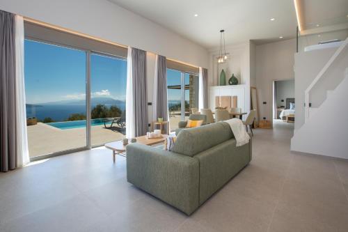 a living room with a couch and a large window at Brand new High-end villa Solar in Sivota