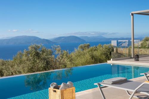 a villa with a swimming pool and a view at Brand new High-end villa Solar in Sivota