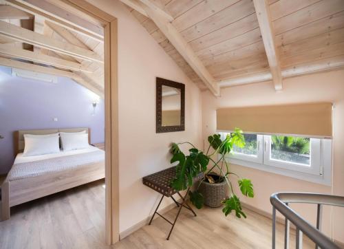 a bedroom with a bed and a mirror at Rigilis by Vintage Travel in Nydri