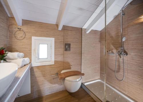a bathroom with a shower and a toilet and a sink at Rigilis by Vintage Travel in Nydri