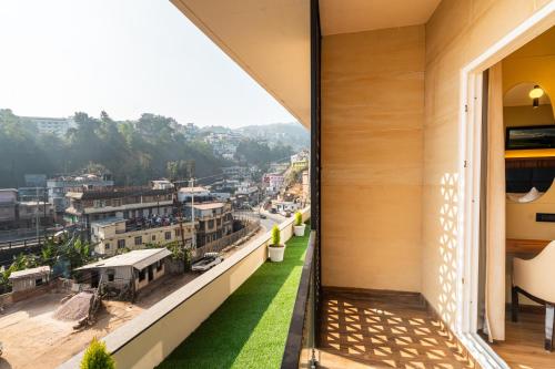 a balcony with a view of a city at The White Rock Inn & Dine in Shillong