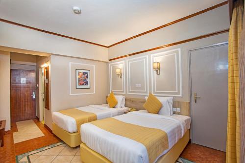 Postel nebo postele na pokoji v ubytování Maanzoni 680 HOTEL