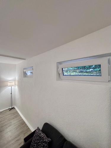 a living room with a window on the wall at Quartier Wenzelnberg in Langenfeld