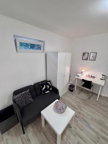a living room with a couch and a table at Quartier Wenzelnberg in Langenfeld