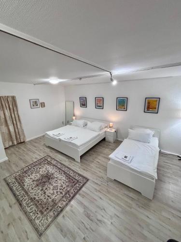 a room with two beds and a rug at Quartier Wenzelnberg in Langenfeld