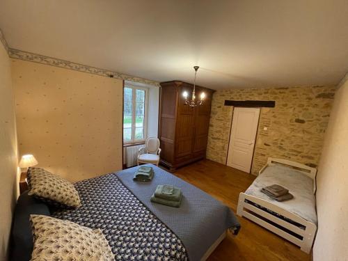 a bedroom with a large bed and a window at Refuge Champêtre - Piscine intérieure - Détente in Salles