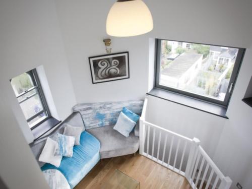 a living room with a couch and a window at The Observatory Tower in Falmouth