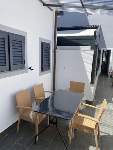 a glass table and chairs on a patio at Casina Viareggina 2 camere in Viareggio