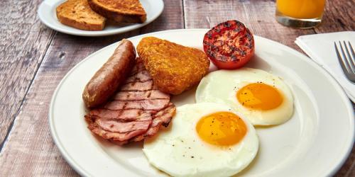 a plate of breakfast food with eggs sausage and toast at Delta Hotels by Marriott Birmingham in Birmingham