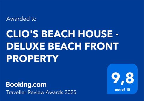 a blue sign that reads clicos beach house deliver beach front property at CLIO'S BEACH HOUSE - DELUXE BEACH FRONT PROPERTY in Órmos