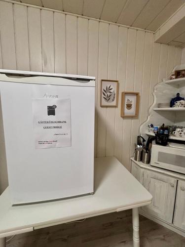 a refrigerator freezer sitting in a kitchen next to a counter at Quartier Wenzelnberg in Langenfeld