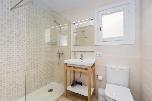 a bathroom with a sink and a toilet and a shower at San Jaime View - stunning sea views close to resort in Son Bou