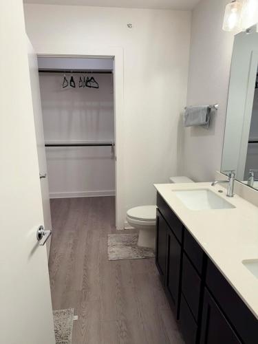 a white bathroom with a toilet and a sink at Peaceful 1BR Stay Leander TX near Austin in Leander