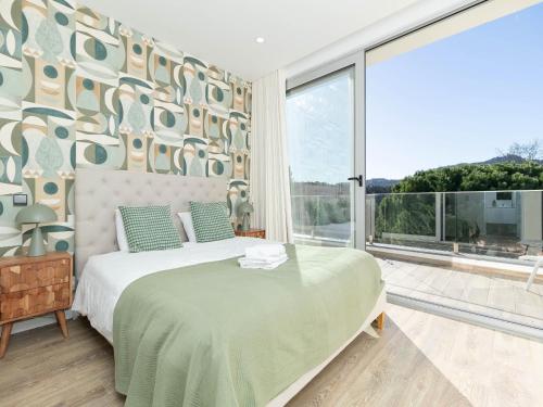 a bedroom with a bed and a large window at Akivillas Sintra Moon in Sintra