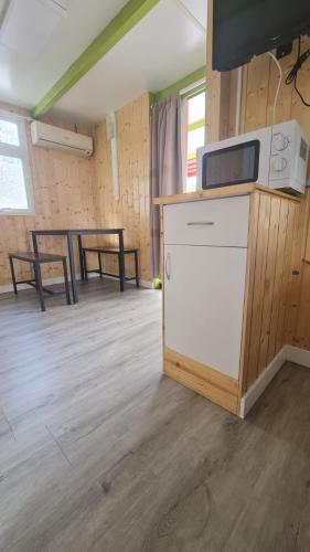 a room with a counter and a table and chairs at Camping Costa Blanca in El Campello