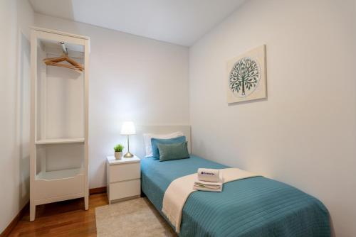 a small bedroom with a bed and a mirror at Spacious Escape Near the Beach by Host Wise in Matosinhos
