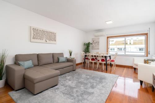 a living room with a couch and a table at Spacious Escape Near the Beach by Host Wise in Matosinhos