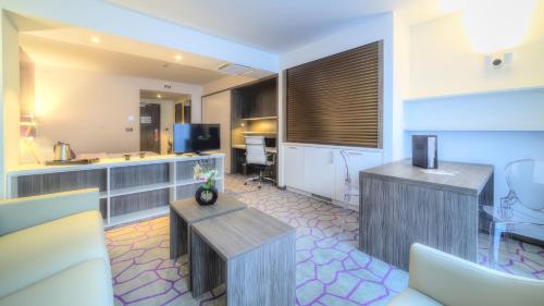 
a living room filled with furniture and a kitchen at Hotel Lido **** Mons Centre in Mons
