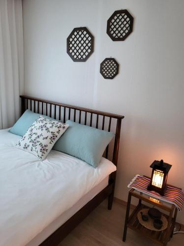 a bedroom with a bed and a table with a lamp at Stay Foret in Seoul