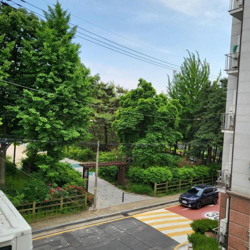 a car parked in a parking lot next to a building at Stay Foret in Seoul