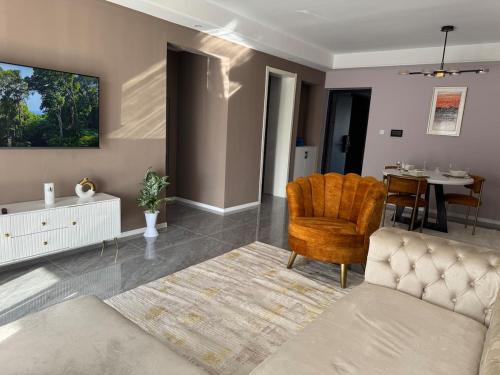 a living room with a couch and a chair at Alba gardens in Nairobi