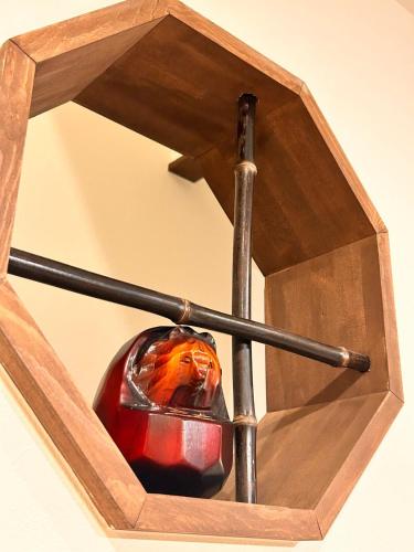 a wooden box with a ball and a baseball bat at 京豊京都駅近辺 in Kyoto