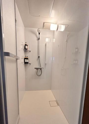 a bathroom with a shower with a glass door at 京豊京都駅近辺 in Kyoto