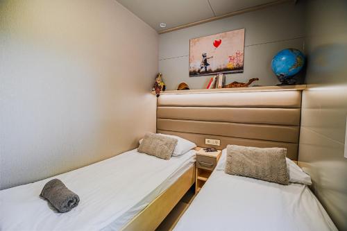 a room with two beds in a room at DELUXE Lake View Mobile Homes with Thermal Riviera Tickets in Čatež ob Savi
