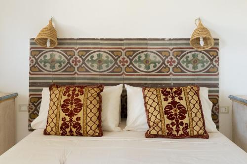 a bedroom with a bed with two pillows at Puloni in Otranto