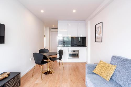 a living room with a couch and a table at VIVA Bartolomeu Beach Flats in Porto