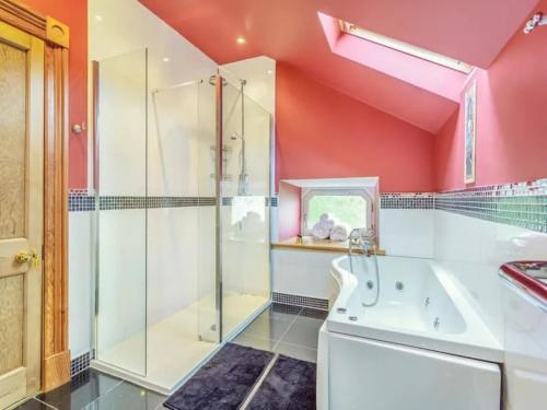 a bathroom with a shower and a tub and a sink at The Doune, Luxury Traditional Country House with hot tub in Inverness