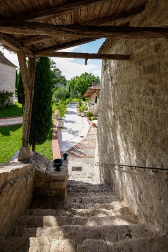an outside view of a stone wall with stairs at Domaine de Saint-Géry - Teritoria in Lascabanes