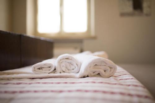 a pile of towels sitting on top of a bed at Ca'Rapulin in Calosso