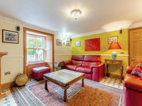 a living room with a couch and a table at The Doune, Luxury Traditional Country House with hot tub in Inverness