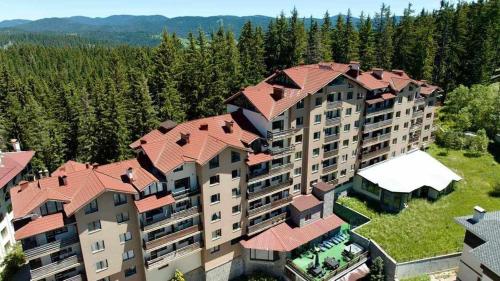 an aerial view of a building with red roof at Pamporovo Rhodopi Pearl Apartments - Private Apartments in Pamporovo