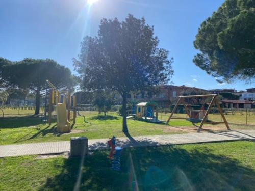 a park with a playground with a swing set at Porto San Paolo a 50 mt dal mare in Porto San Paolo