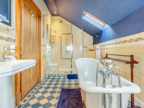 a bathroom with a tub and a sink and a shower at The Doune, Luxury Traditional Country House with hot tub in Inverness
